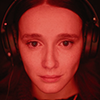 monalizard: A screenshot from the movie "Les Chambres Rouges". A close-up of Kelly-Anne's face basked in the red light of her computer. (movies2024)