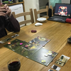 purplecat: A tiled boardgames with an app on a laptop laid out on a table. (General:Board Gaming)