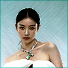 mumblemumble: ni ni doing a serious-face model pose, with only her bare shoulders, chunky necklace, and the top of a white gown visible ([ladies] high fashion)