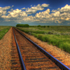 marci: A photo of train tracks cutting through a rural countryside. (default, midwest, rural, tracks)