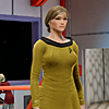 anghraine: A female version of Kirk from Star Trek made in Star Trek Online; she is a curvy woman wearing the TOS miniskirt in command gold; she has dark blonde hair pulled away from her face (jessica [close])