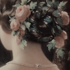 selkiette: The roses and greenery woven into a light-skinned woman’s bun. (Default)