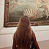 yarnofariadne: a woman with long brown hair viewed from behind, looking at botticelli's birth of venus (misc: someday we'll be lions)