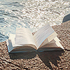 yarnofariadne: an open book on the side of a pool (misc: swallowed by the waves)