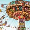 abyssal_sylph: a  flying carousel behind a bright blue sky. (sunshine challenge)