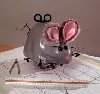 musigneus: small gray wind-up mouse sitting on a stack of technical drawings (Default)
