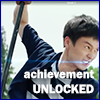 amedia: Young Chinese man, looking very focused,  successfully wielding a baton against a blue energy string; caption reads ACHIEVEMENT UNLOCKED (Guardian: GCC Achieve)