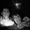 withnailandinsfw: Black and white image of Withnail and Marwood from Withnail and I, partially hidden under some covers and looking up with surprise and anger. (withnail and i nsfw community)