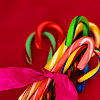 trillingstar: festive | a bundle of multi-coloured candy canes tied with a pink bow (gen holiday candy)