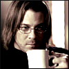 rhoda_rants: Screenshot of Christian Kane as Eliot Spencer, wearing glasses, black sweater, sipping out of coffee mug, and looking vaguely threatening. (christian kane)