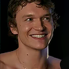 maevedarcy: Ilya Rozanov from Heated Rivalry smiling shirtless (Default)