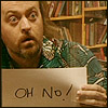 galadhir: The comedian Bill Bailey holds up a hand lettered sign that says Oh No! (He has just locked his boss out of the building.) (Oh no!)