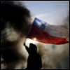 maevedarcy: silhouette of a person holding the Chile flag at a protest. There's a column of smoke at the back (chile)