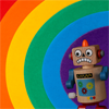 sweettartheart: A toy robot with an anxious expression beginning to cross a rainbow of colors (Robot Grr Rainbow)