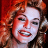 queenslayerbee: Laura Palmer at the end of Twin Peaks: Fire Walk With Me. She's in the red room with those curtains behind her, and the icon shows a close up of her face, illuminated by artificial light, as she has a huge, teary-eyed grin in her eyes. (Default)