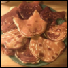 yourownbestfriend: A plate of pancakes that are shaped like cat faces. (Default)