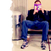 deelaundry: man reading in an airport with his face hidden by the book (Default)