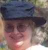 redbird: close-up of a smiling woman wearing a hat (hay)