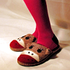 chalcopyrite: A pair of feet wearing slippers with sock monkey faces. (shoes: monkey slippers)