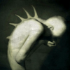 ignotussomnium: A pale, thin figure turned to the side, covering its face with its hands. Long spikes stick out of its spine. ([Stock] Good luck finding a shirt)