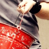 tea: close-up of a red bucket in adam lambert's nail-polished hand (red bucket)