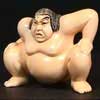 firecat: statuette of sumo wrestler crouching (sumo)