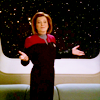 medie: Kathryn Janeway backlit by stars with her hands out in a 'well' gesture with a big smile on her face (trek - voyager - big damn captain)