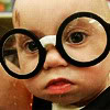 jesse_the_k: Baby wearing black glasses bigger than head (eyeglasses baby)