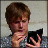 msilverstar: Bradley James as Arthur (offscreen, using a PDA) (mythacronism)
