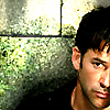 mific: John sheppard looking sad or worried against stone wall, half out of frame (Shep - sad)