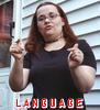 ext_27139: A photograph of me in a black dress, signing "LANGUAGE" in ASL.  The word "language" is printed at the bottom. (linguist)