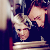 peoriapeoriawhereart: blond and brunet men peer intently (Napoleon & Illya peer)