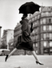 leonie_alastair: B/W Avedon captures a model w/umbrella in midair leaping over a puddle (Default)
