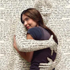 shirasade: a person with text all over stepping out of a book to hug a young white woman (book hug)