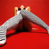 catechism: chick in black & white stripey socks against red background (socks)