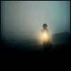 ext_161: woman walking through fog with flashlight (into the dark)