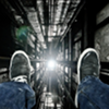 go_dog_go: A person's legs and feet dangling over the edge of a very tall building at night (vertigo)