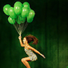 gizmometer: girl jumping/floating with a big bunch of bright green balloons, over a dark green background (how exciting)