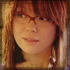 randomling: Toshiko Sato (Torchwood), wearing glasses, smirks. (tosh smirks)