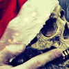 binz: close up of the bob!skull from 'the dresden files' show, held by a hand and wearing a santa hat. ([ dresden seasonal ] not the hogfather)