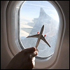 jenna_thorn: a toy airplane framed by an airplane window (Travel)