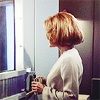 medie: Kathryn Janeway in a robe with a coffee cup in hand staring into a mirror, her face is not visible (trek - voyager - solitary captain)