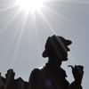 flourish: The statue of Sherlock Holmes in London, with hat and pipe, silhouetted against the sky. (Holmes)