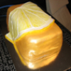 aquaeri: A cake in the shape of a slice of lemon wrapped around a large gold brick (gold brick)