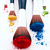 scheherezhad: five various makeup brushes with different pigment powders on them (brushes)