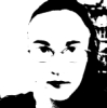 crystalpyramid: black-and-white super-high-contrast photo of myself, long dark hair, small thick glasses, serious expression (photo)