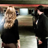 lilly_c: Maura and Tommy standing in a car park looking ahead (Maura & Tommy - car park)