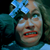 laughingrat: A still from "The Horror of Dracula" in which someone presses a cross to a vampire's forehead. (RELIGION)