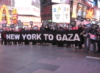 ajnabieh: Protesters in Times Square, holding a banner reading "New York To Gaza" in front of a neon McDonalds. (gaza)