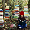 muccamukk: Girl sitting on a forest floor, reading a book and surrounded by towers of more books. (Books: So Many Books)